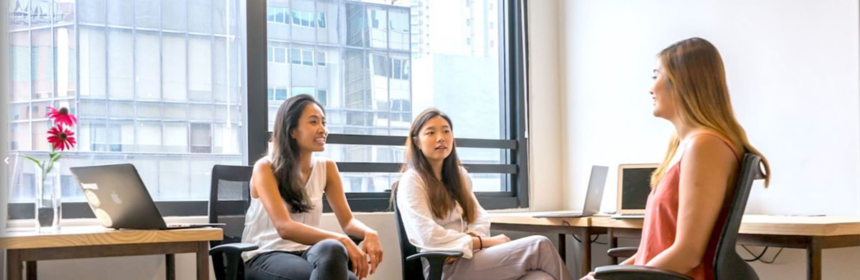 Bright coworking space with modern desks, ample lighting, and a collaborative atmosphere.