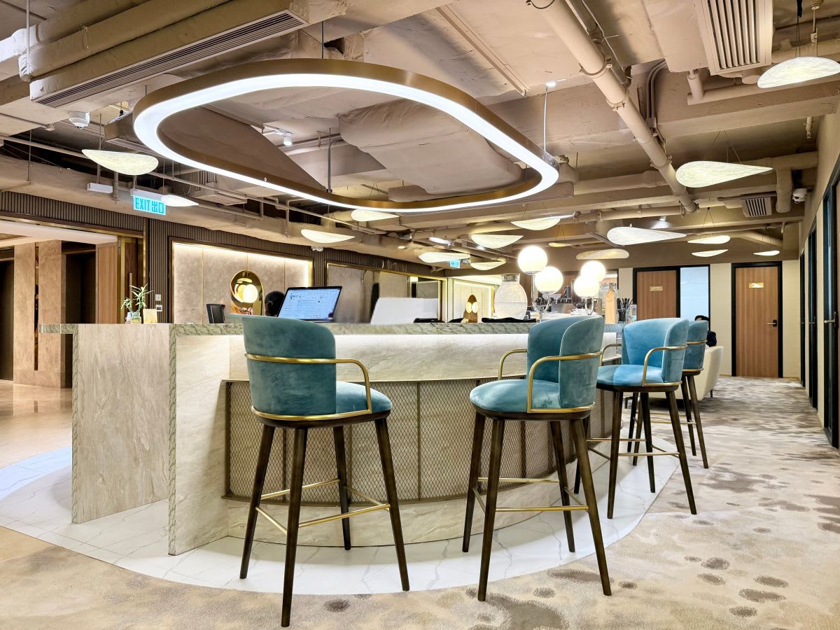 Sleek coworking space with modern bar seating and ambient lighting in Central Hong Kong.