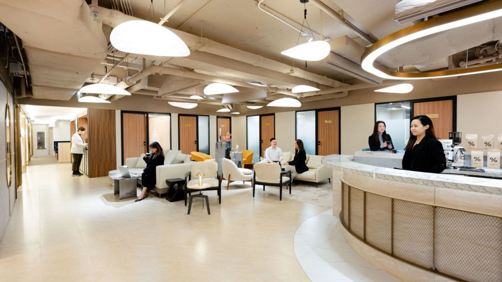 Modern coworking space in Central Hong Kong with sleek design, cozy seating, and vibrant lighting.