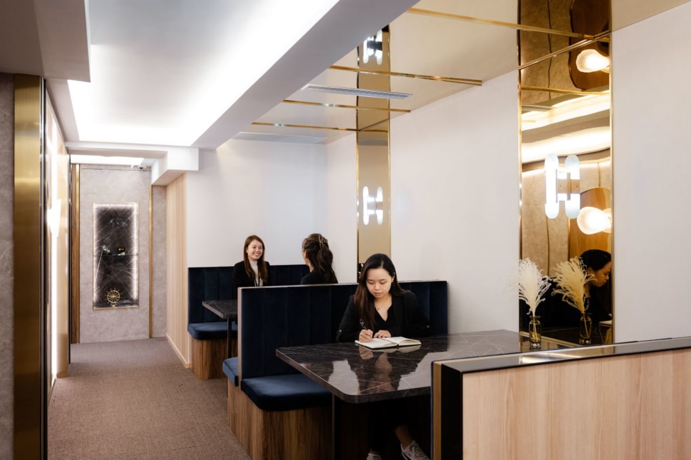 Elegant coworking space with plush seating and modern lighting in Central Hong Kong.