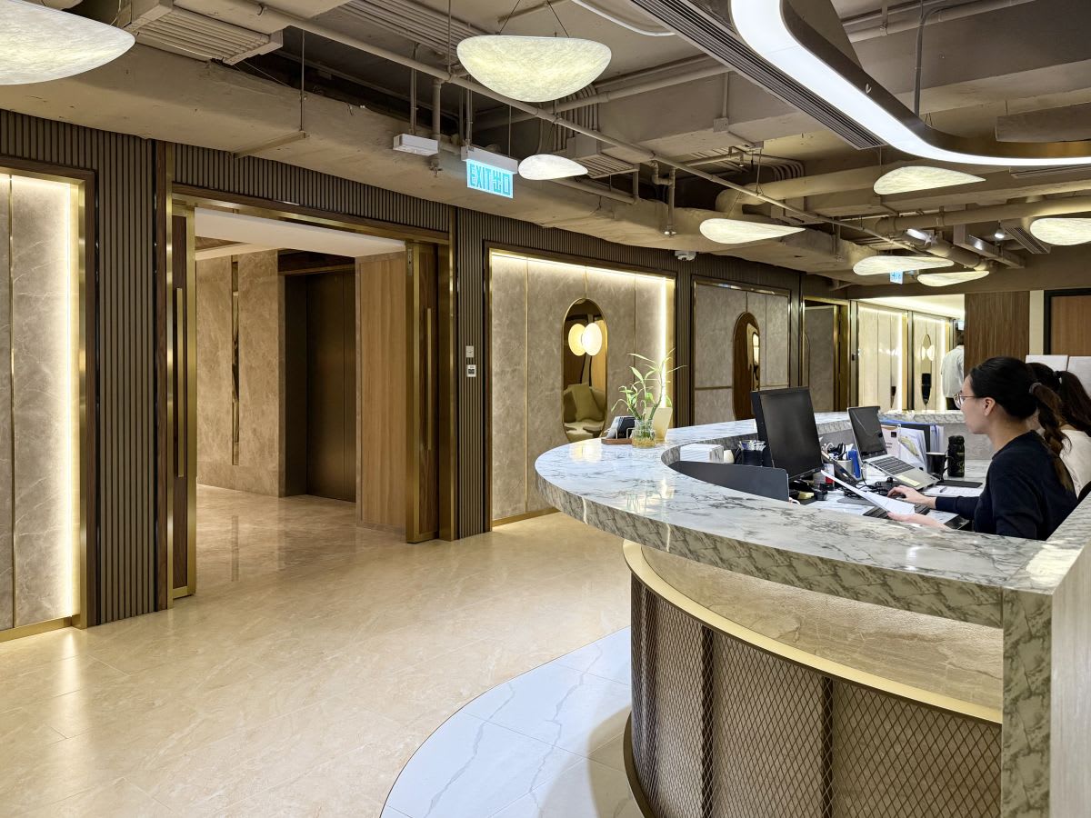 Elegant coworking lobby with modern lighting and sleek reception. Located in vibrant Central Hong Kong.
