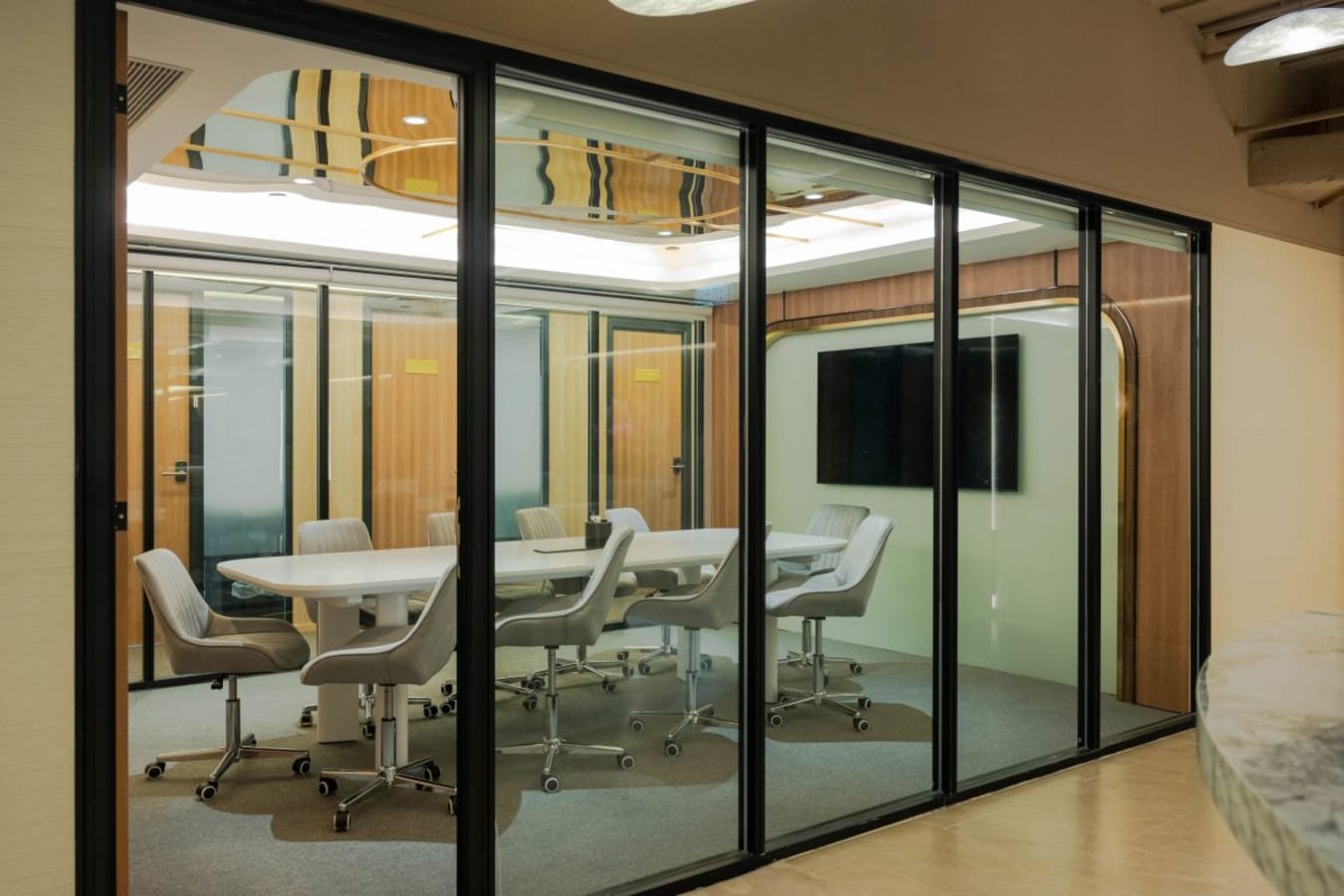 Modern conference room with sleek glass walls and executive seating in Central Hong Kong coworking space.