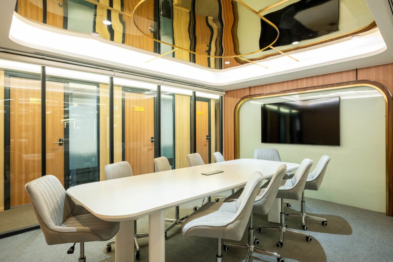 Elegant meeting room with sleek table, modern chairs, and state-of-the-art screen in Central Hong Kong.