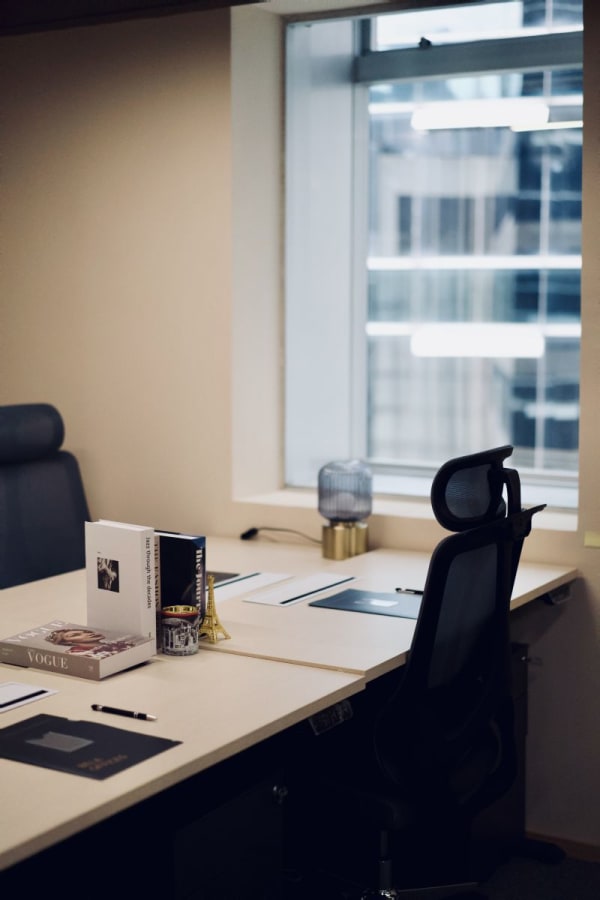 Sleek coworking desk with ergonomic chair, natural light, and city views in Central Hong Kong.