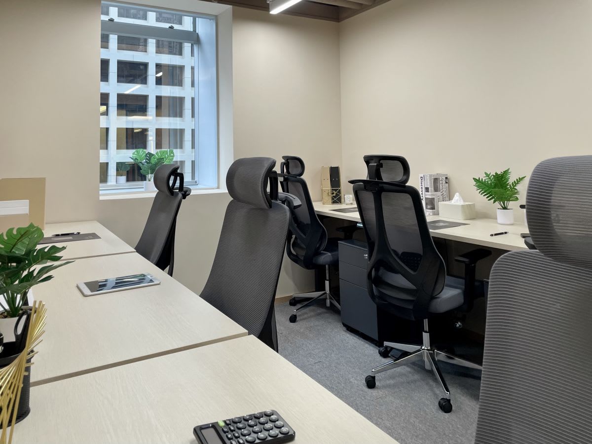 Modern coworking space in Central Hong Kong with ergonomic chairs and ample natural light.