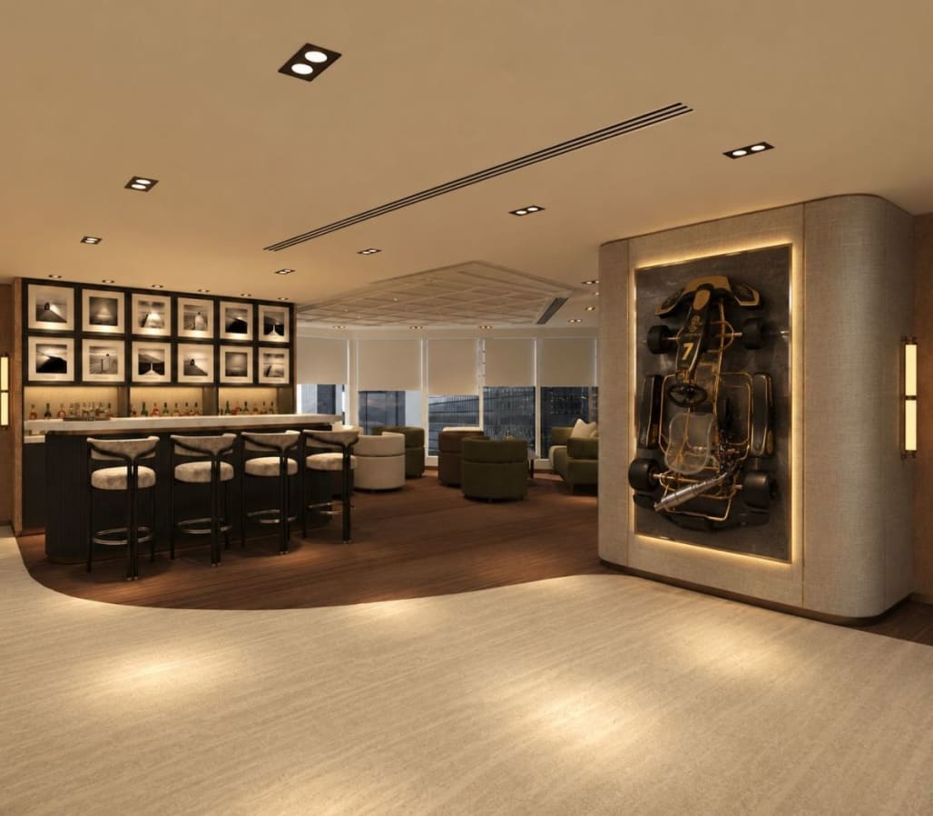 Stylish coworking lounge with bar seating and art display, perfect for networking and relaxation.