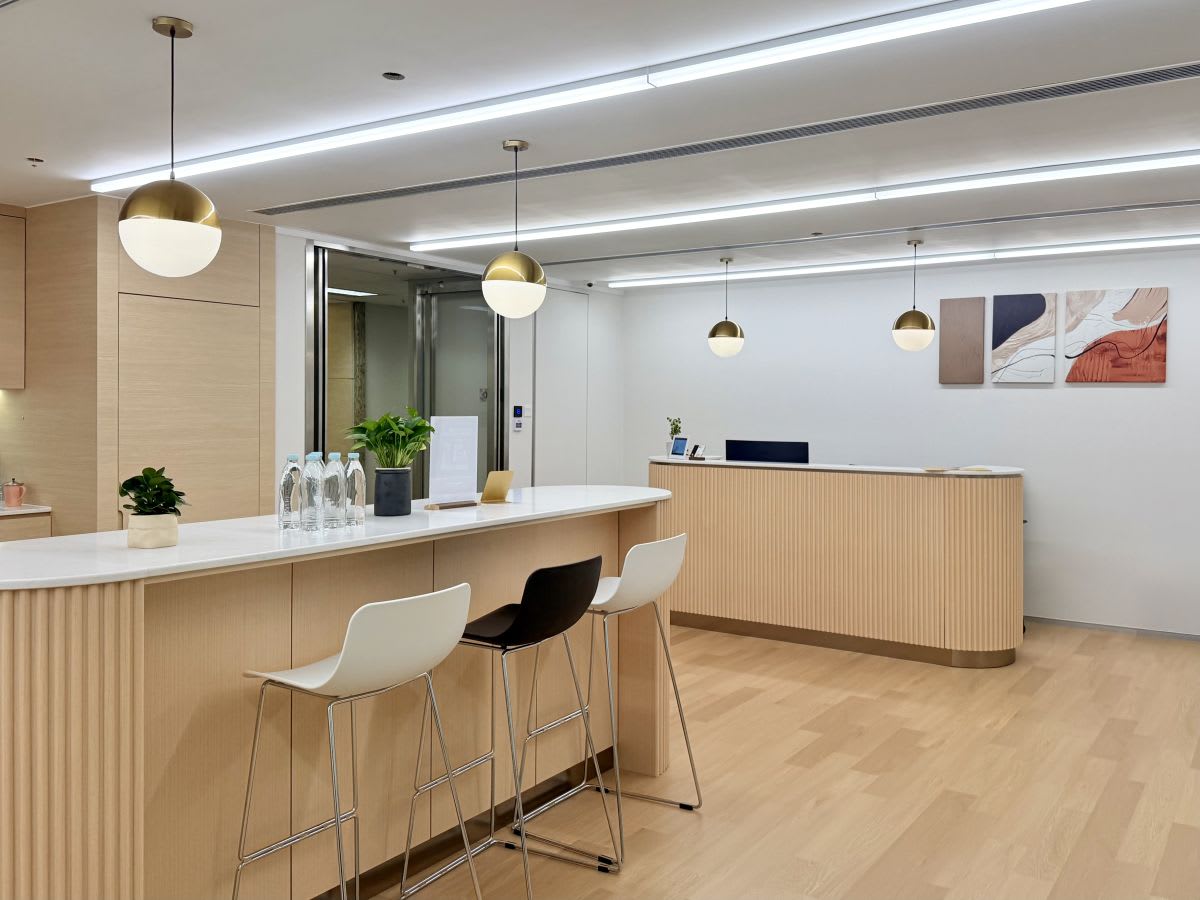 Modern coworking space with sleek counters, stylish lighting, and a welcoming atmosphere.
