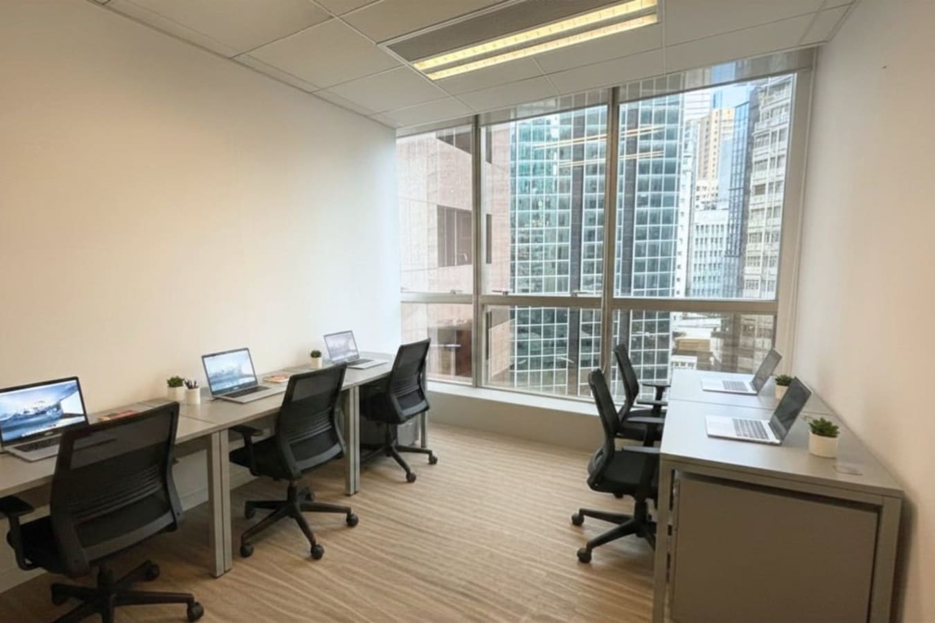 Bright coworking space with city views, modern desks, and ergonomic chairs in Tsim Sha Tsui.