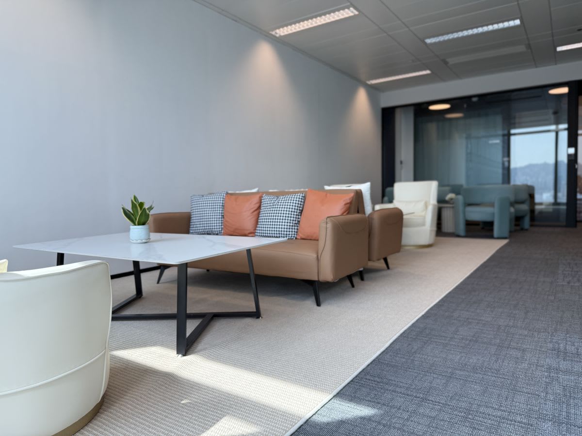 Sleek coworking space with modern seating, natural light, and stylish decor in Kwun Tong.