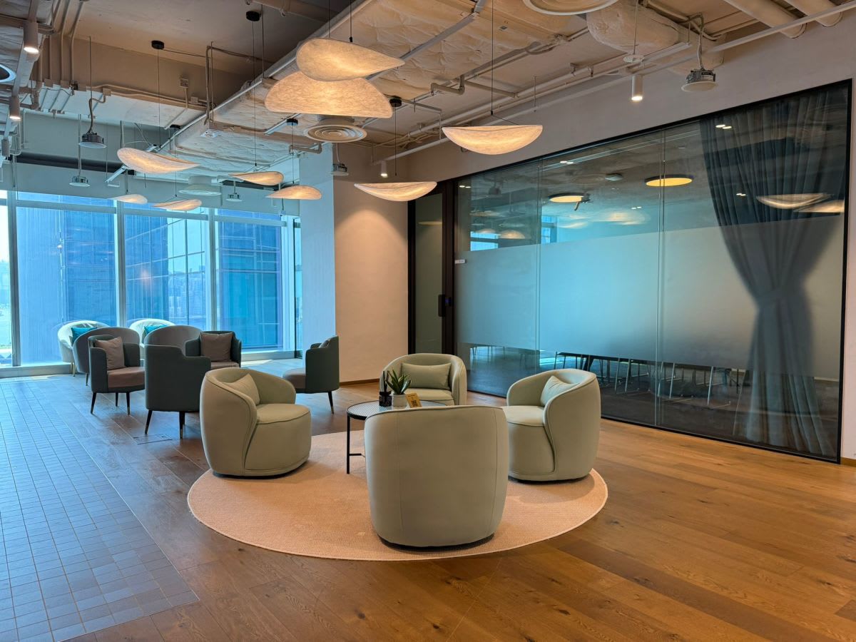 Modern coworking space with plush seating, natural light, and a stylish open design in Kwun Tong.