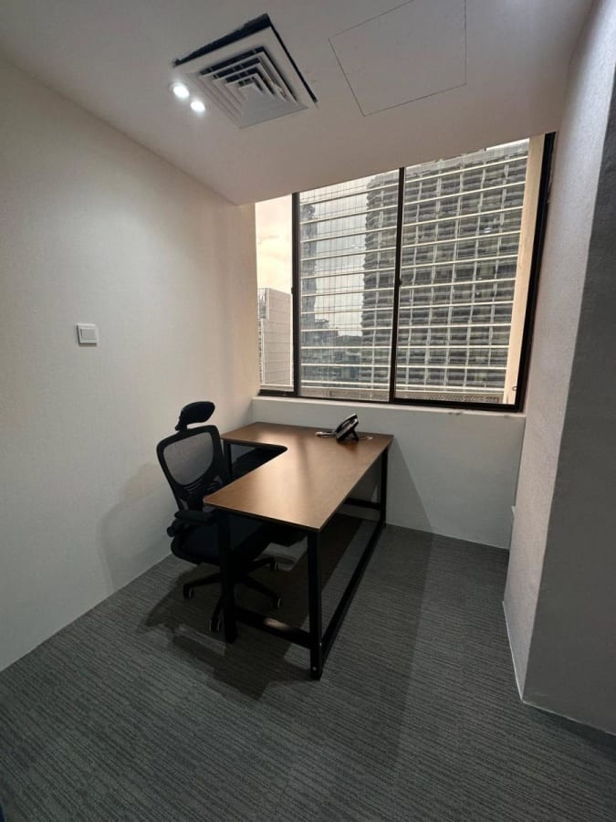 Compact office with city views, ergonomic chair, and ample natural light. Ideal for private work.