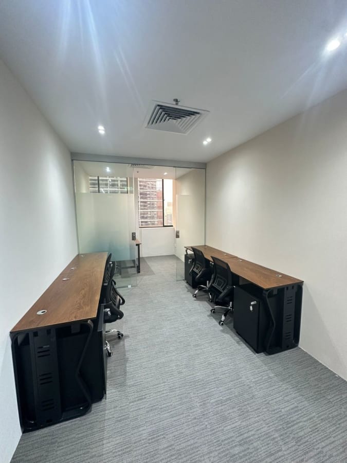 Modern coworking space with sleek desks, ergonomic chairs, and natural light. Ideal for productivity.