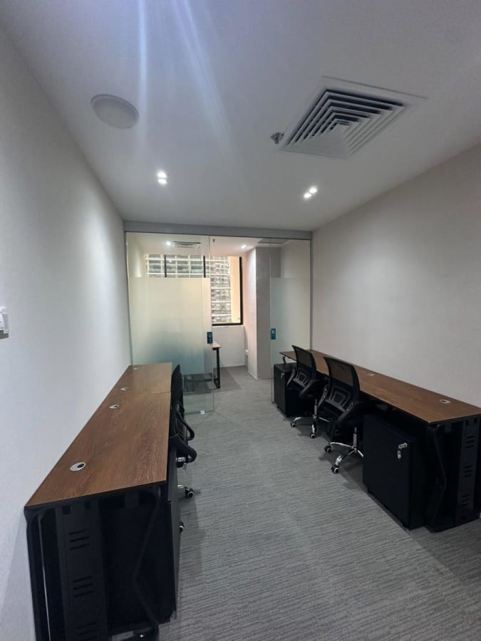 Sleek coworking space with natural light, comfy chairs, and modern wooden desks on Anson Road.