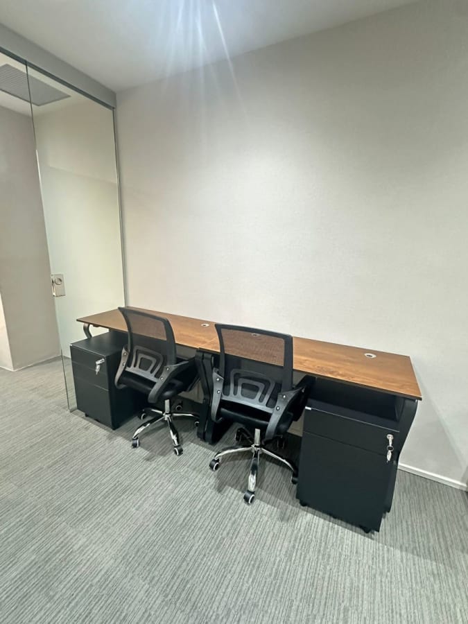 Sleek coworking setup with modern desks and ergonomic chairs. Ideal for collaboration.