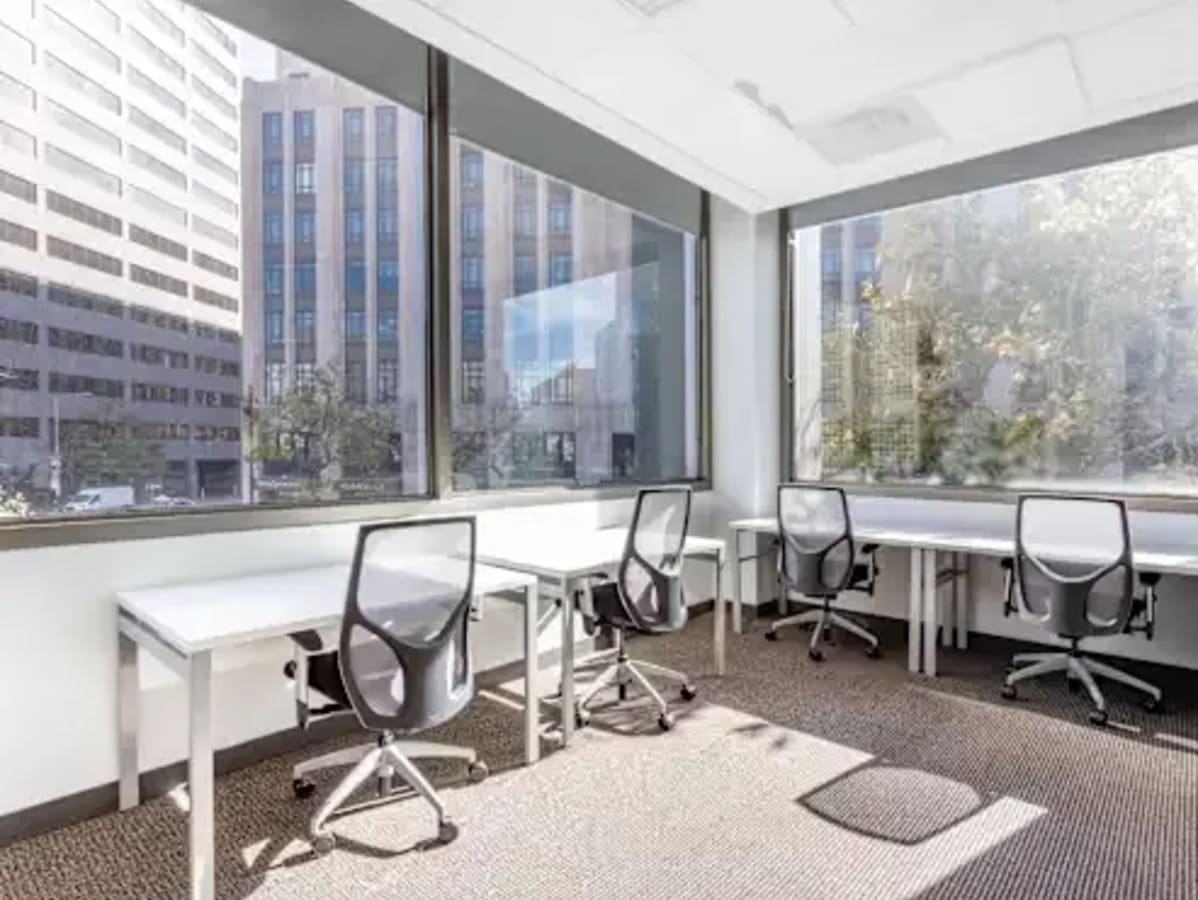 Bright, airy coworking space with modern desks and ergonomic chairs, ideal for productivity.