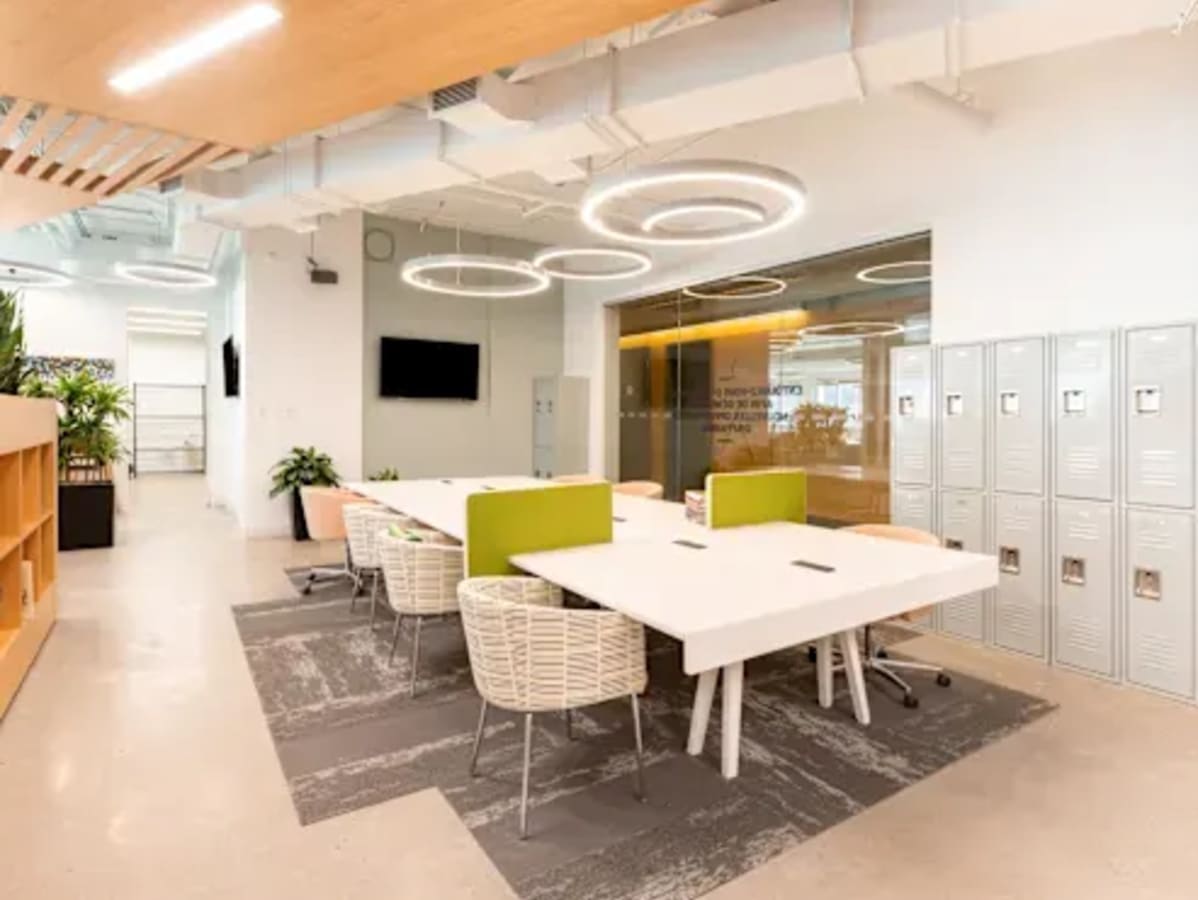 Modern coworking space with stylish seating, lockers, and vibrant lighting in Hiap Hoe Building.
