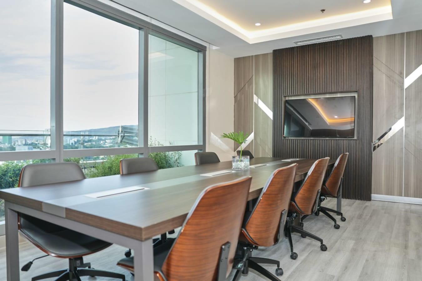 Sleek meeting room with modern design, natural light, and city views. Ideal for productive sessions.