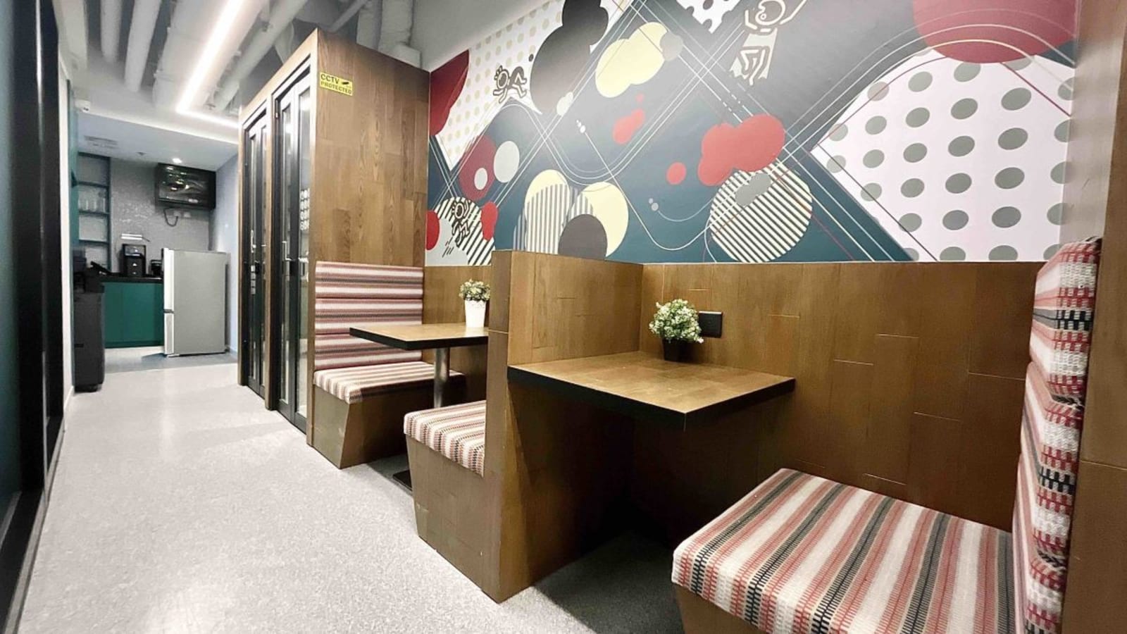Modern coworking booths with vibrant decor in Sheung Wan's flexible office space.