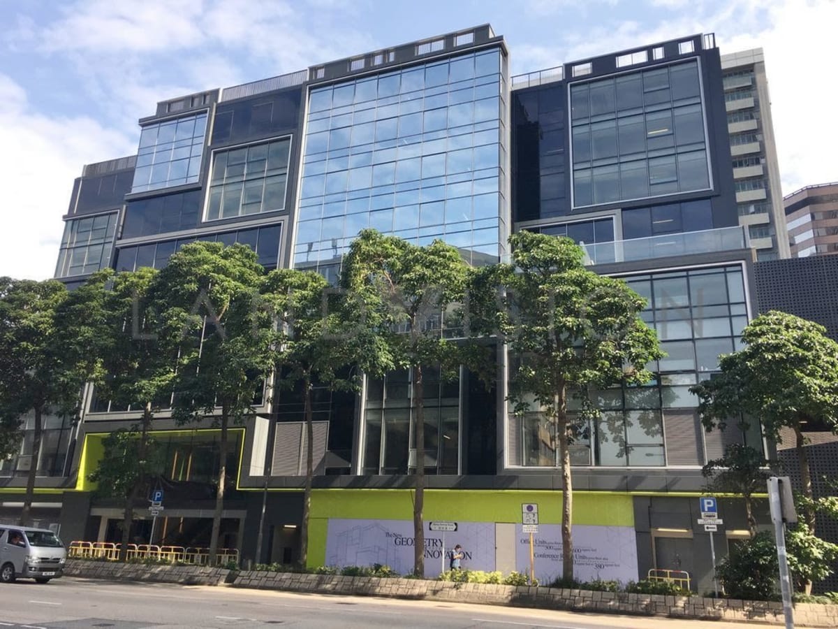 Modern coworking space in Kowloon with sleek glass facade and lush greenery. Ideal for flexibility.