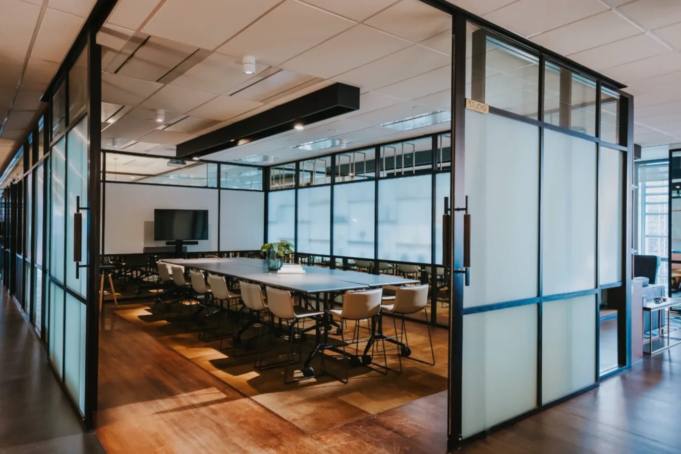 Elegant, open meeting room with ample seating, modern decor, and natural light. Perfect for collaboration.