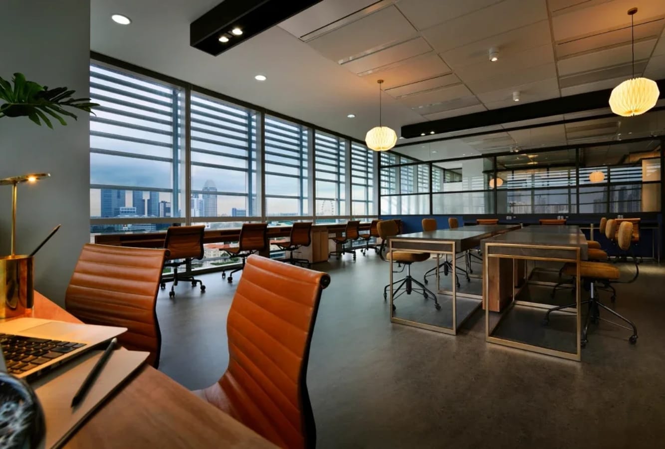 Modern coworking space with spacious desks, ergonomic chairs, and city views. Perfect for collaboration.