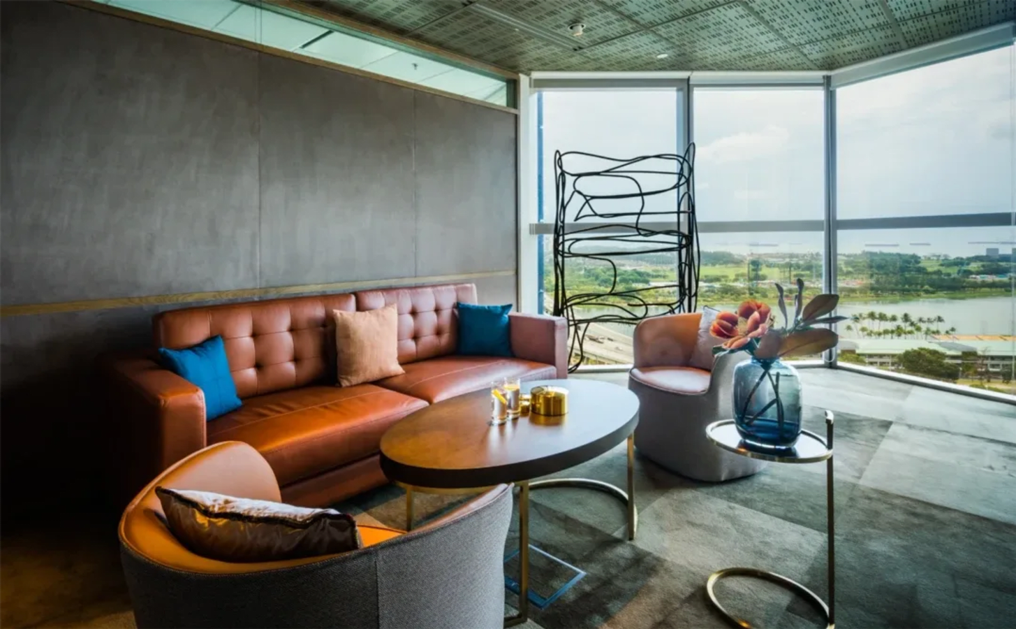 Stylish coworking lounge with plush seating and stunning city views. Ideal for networking.