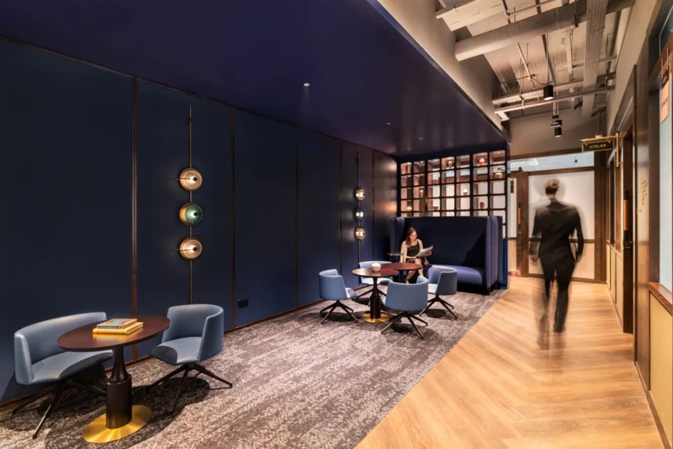 Modern coworking lounge with elegant lighting and sleek furniture in Singapore.