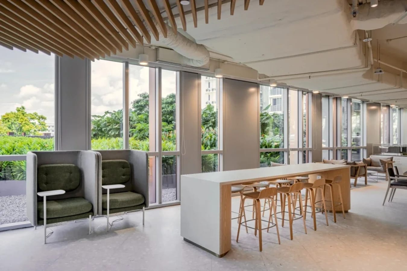 Modern coworking space with natural light, collaborative seating, and serene views.