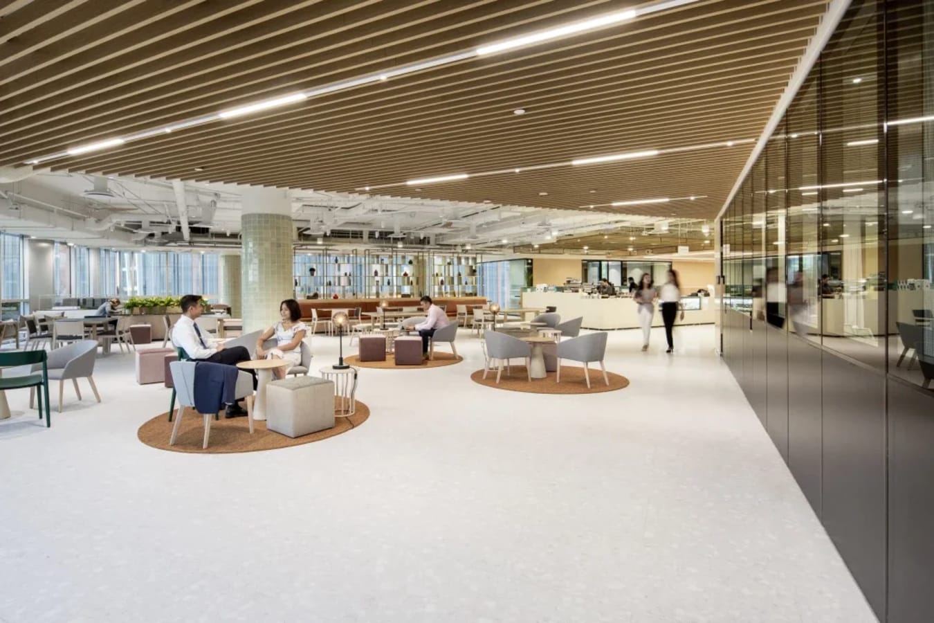 Modern coworking space with open layout, cozy seating, and abundant natural light. Ideal for collaboration.