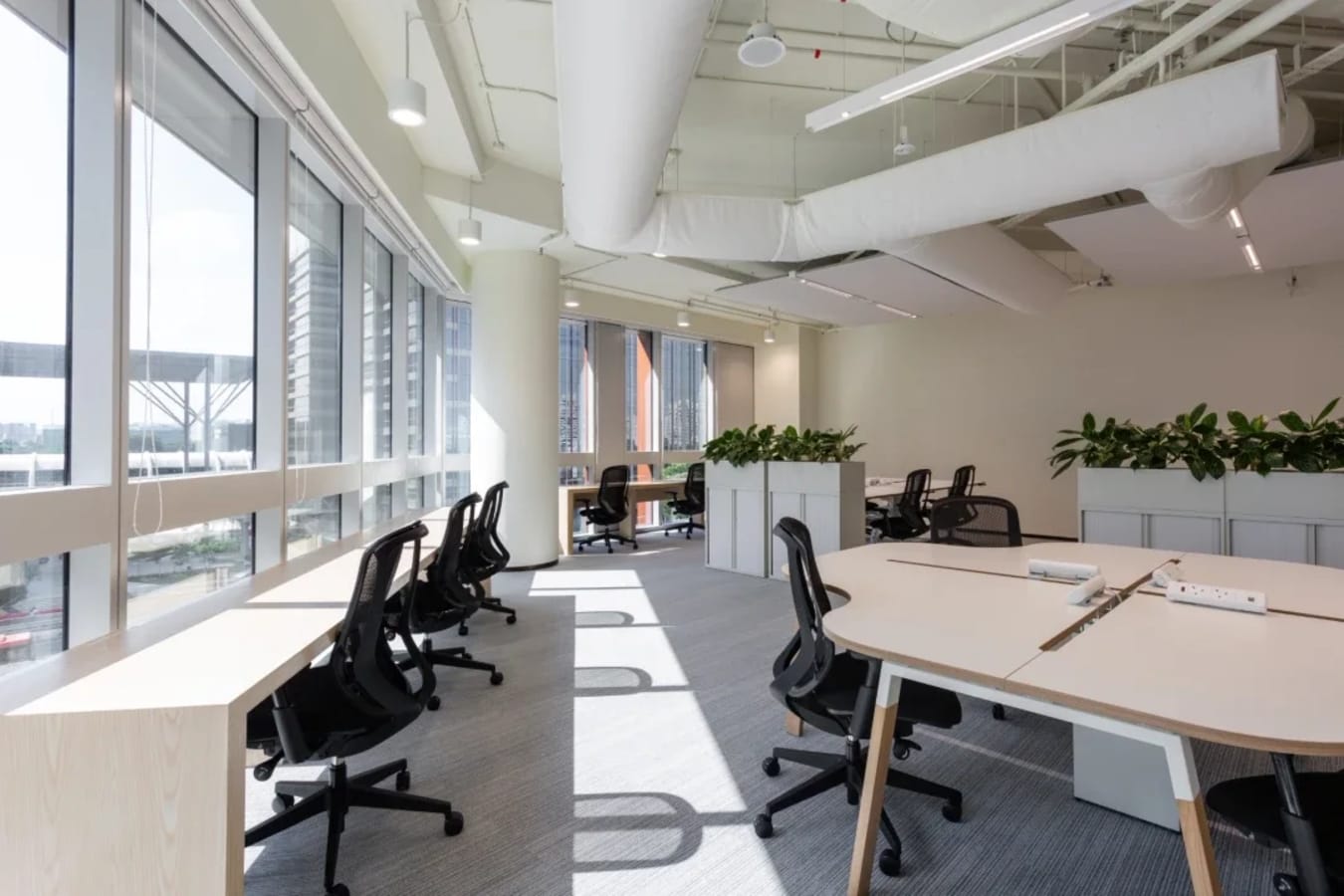 Bright coworking space with modern furnishings and natural light in Singapore. Ideal for productivity.