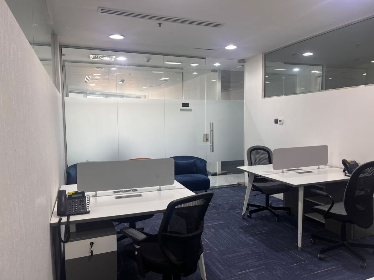 Modern coworking space with sleek desks, comfortable chairs, and natural lighting. Ideal for productivity.