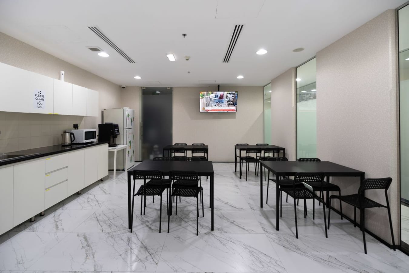 Spacious break area with modern amenities and seating. Ideal for team collaboration and relaxation.