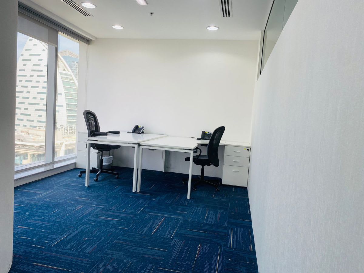 Bright, modern workspace with city views, ergonomic chairs, and ample natural light.