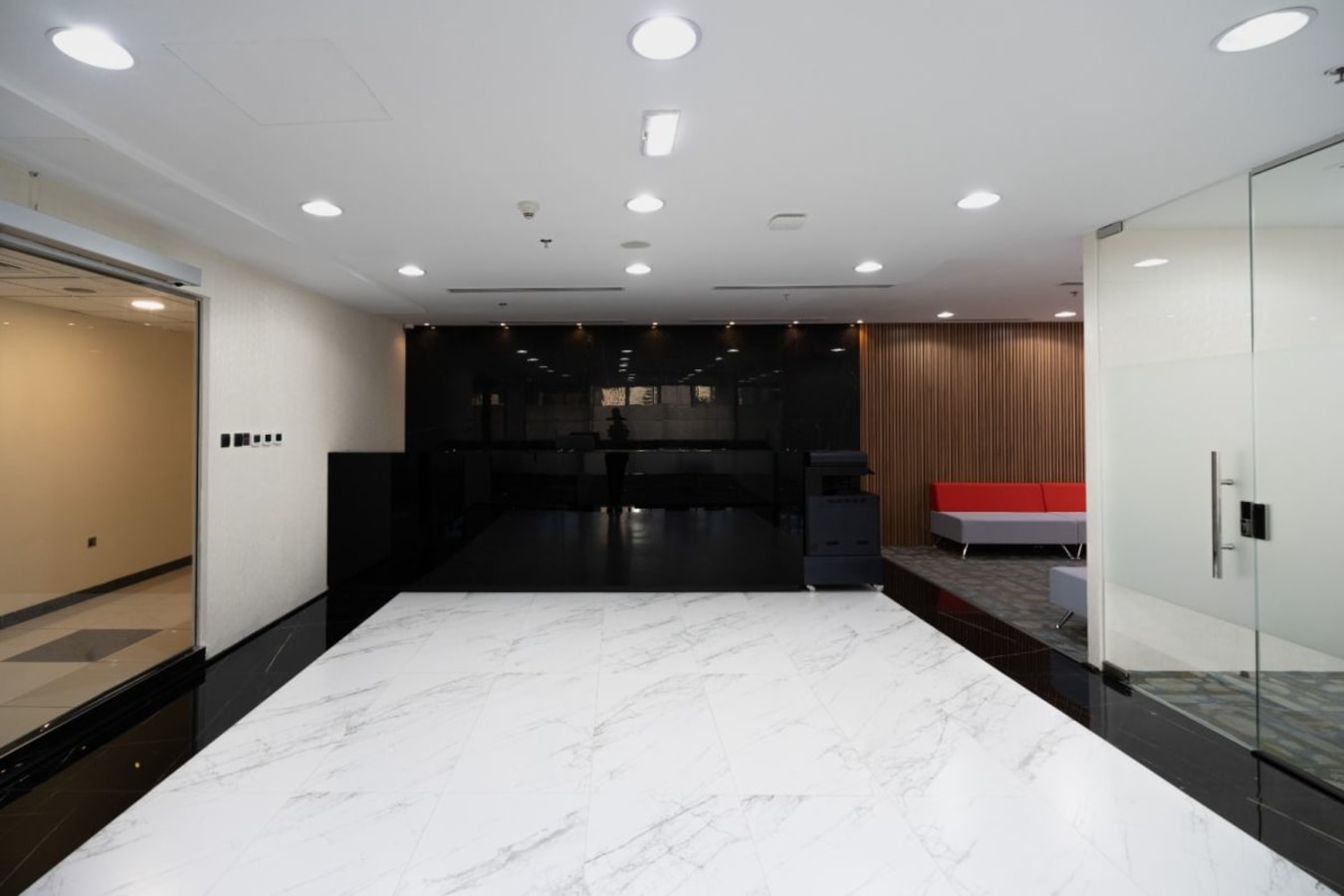 Stylish coworking area in Business Bay with marble floors and modern seating.