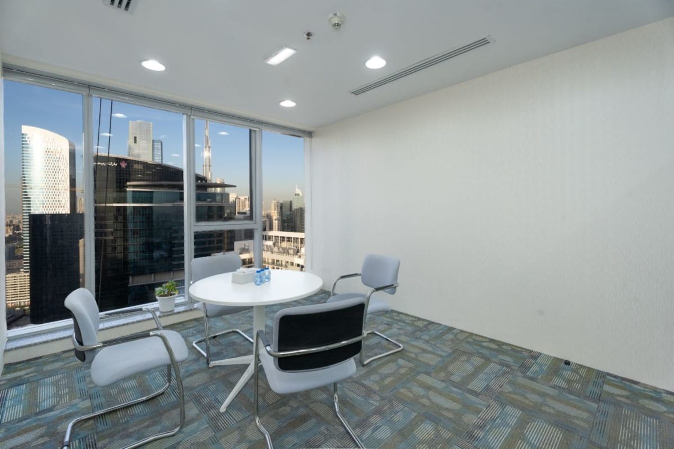 Elegant meeting room with city views, modern decor, and natural light in Business Bay.