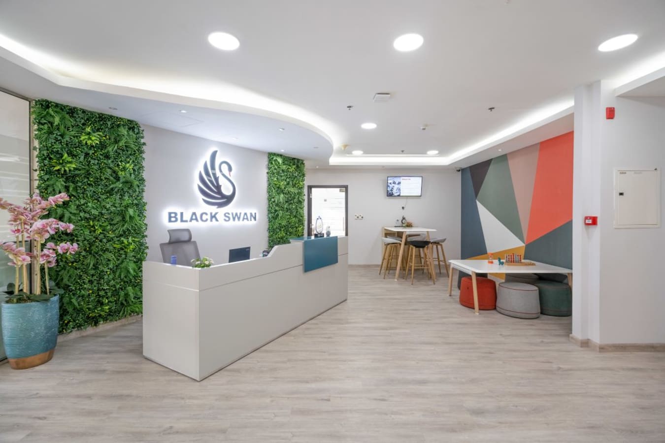Stylish coworking space with vibrant decor and greenery in Business Bay, Dubai.