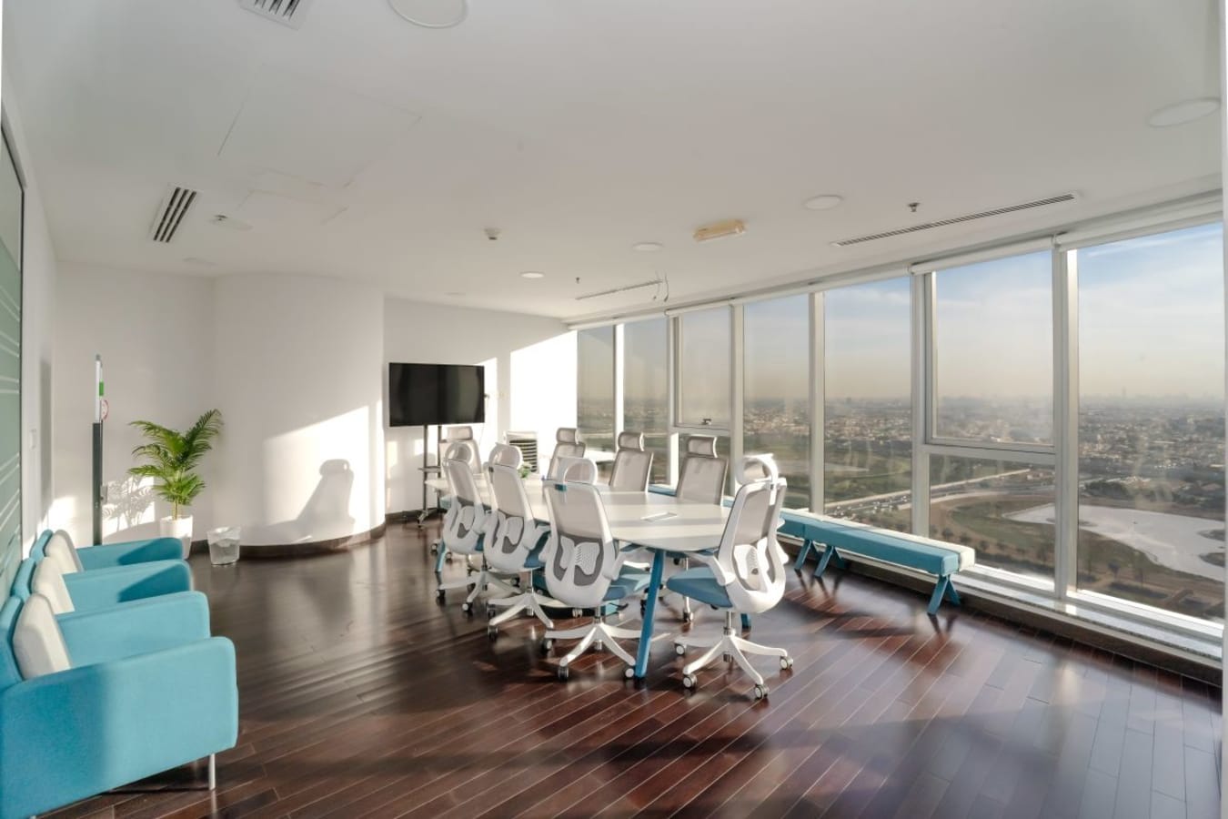 Bright and spacious meeting room with city views and modern seating in Business Bay, Dubai.