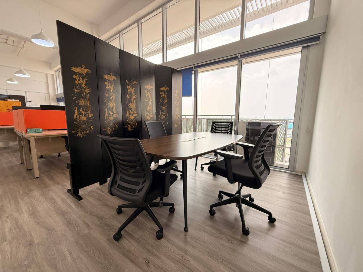 Modern coworking space with natural light, stylish decor, and ergonomic seating in Shenton Way.