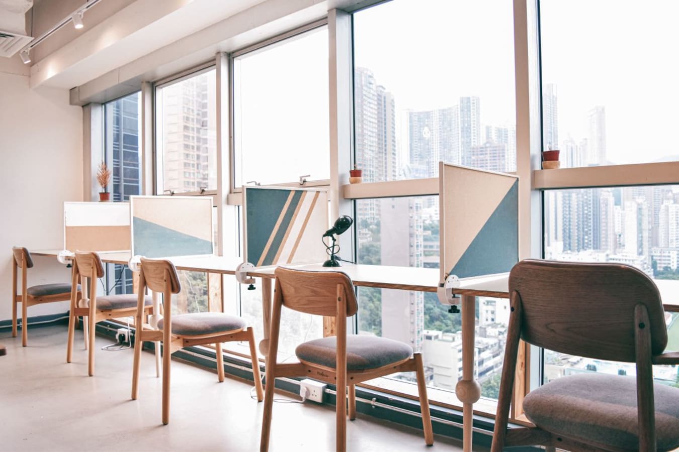 Bright, modern coworking space with large windows and city views on Leighton Road.