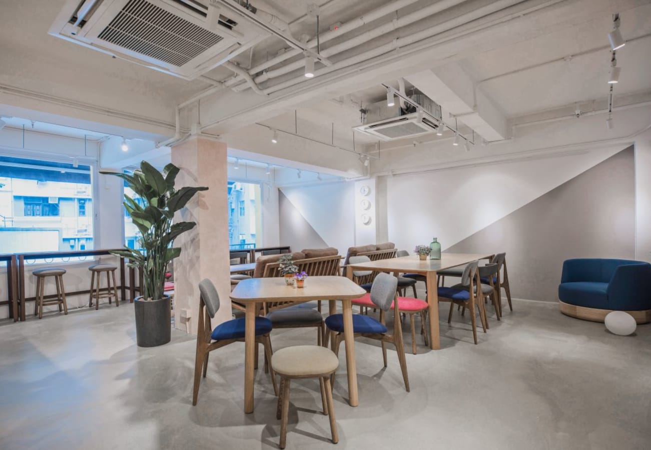 Bright, modern coworking space in Wan Chai with versatile seating and natural lighting.