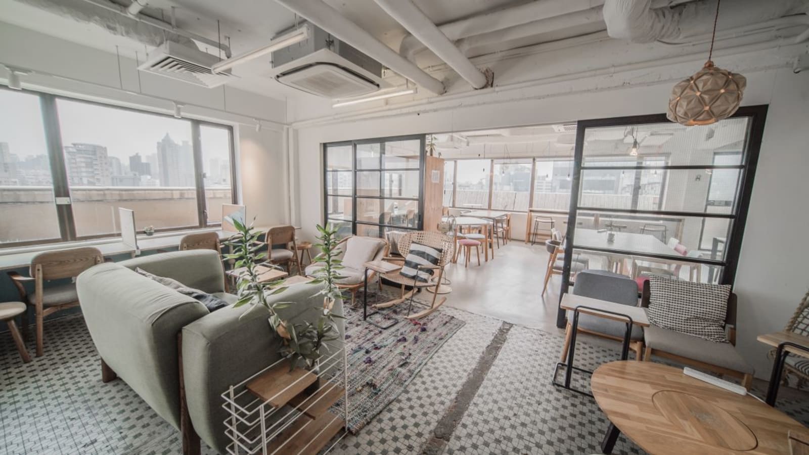 Stylish coworking space with open seating, natural light, and modern decor on Shantung Street.