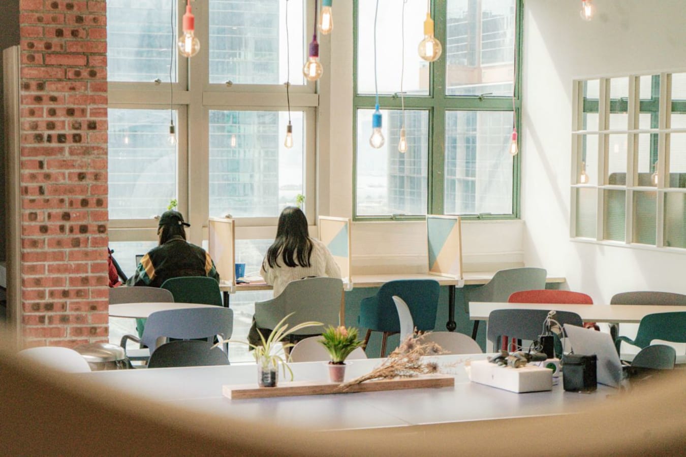 Bright, modern coworking space with natural light and individual workstations. Ideal for productivity.