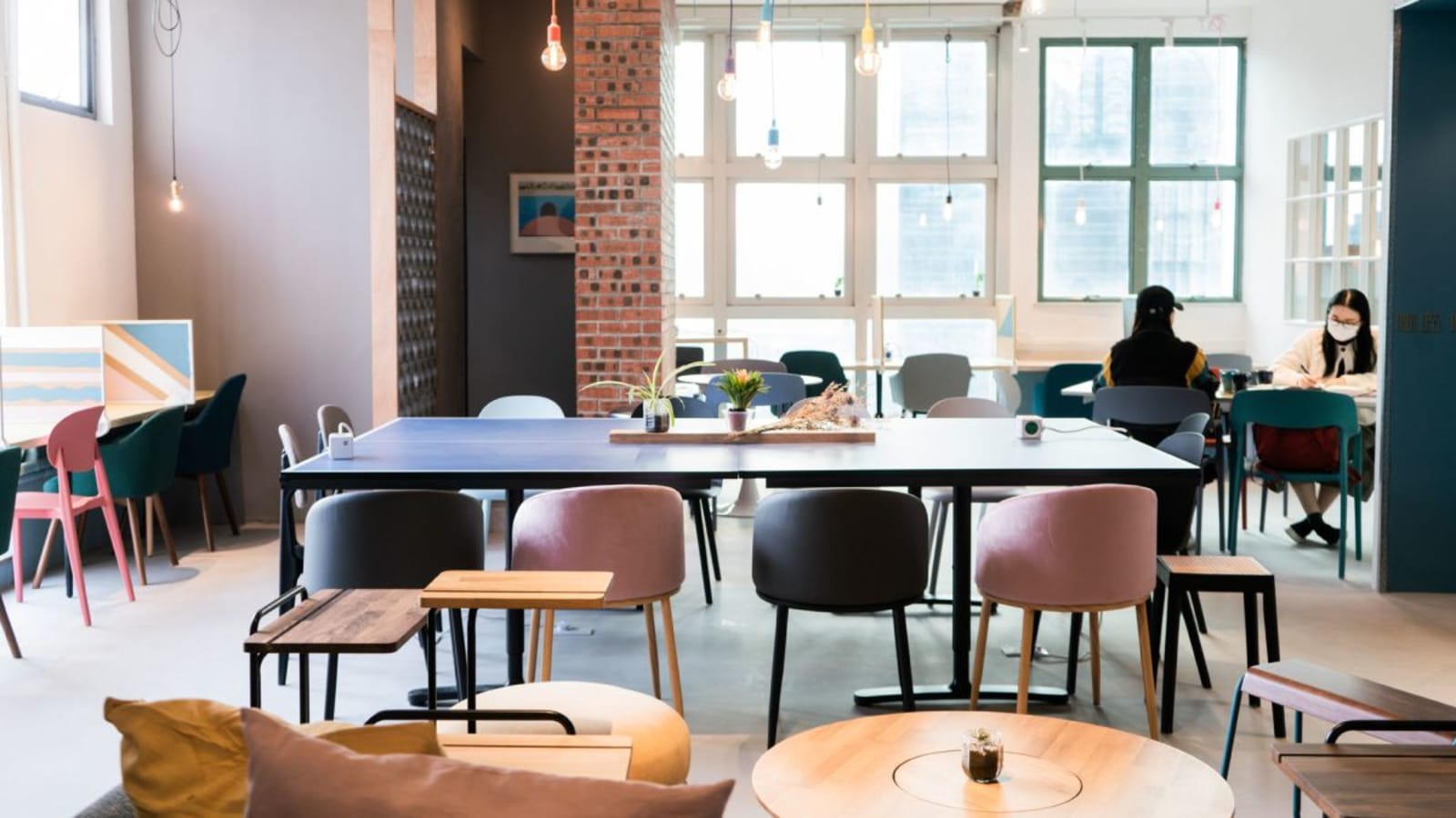 Stylish coworking space with modern seating, natural light, and vibrant decor in Kowloon.