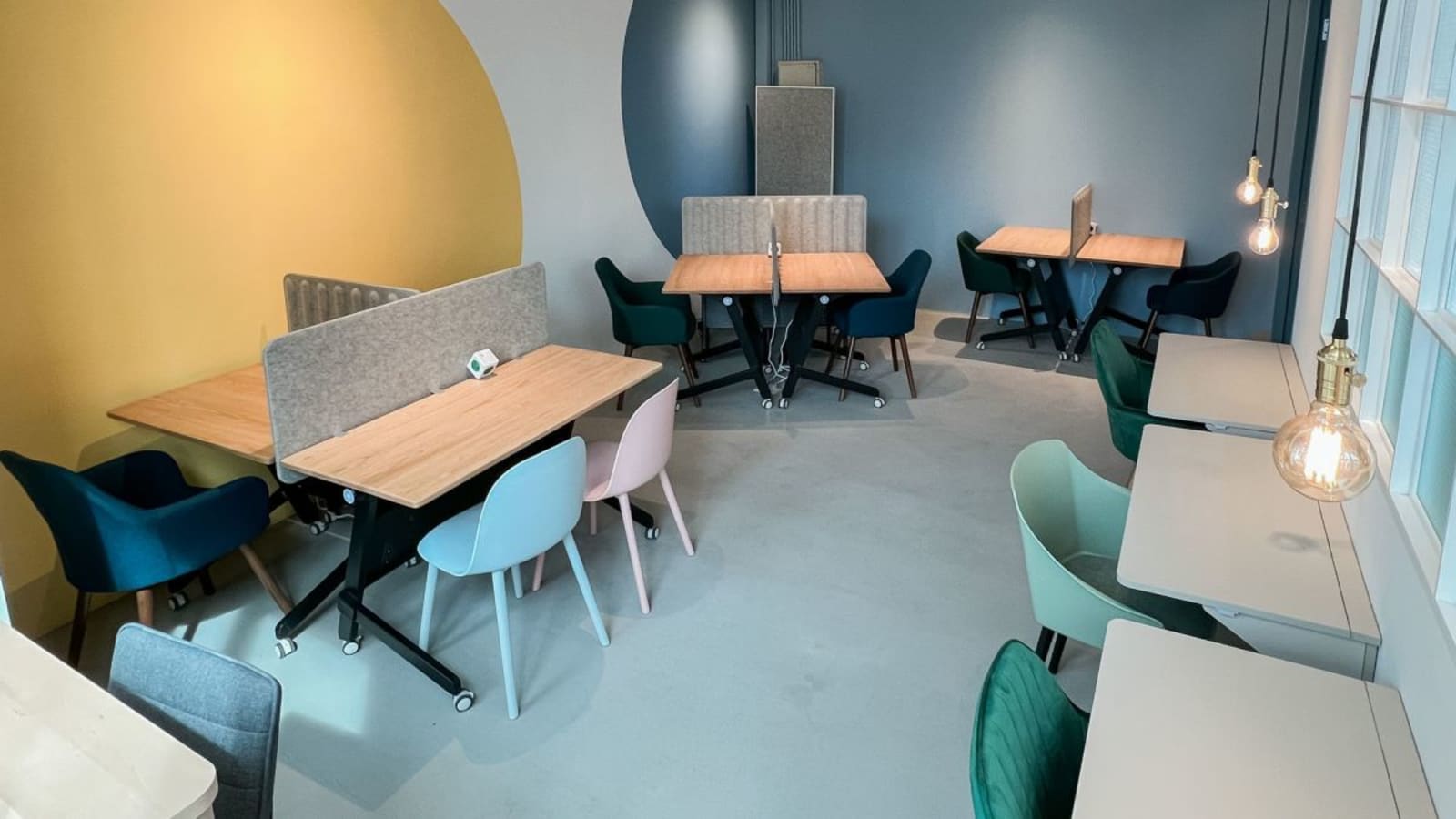 Bright, modern coworking space with cozy seating and stylish dividers on How Ming Street.