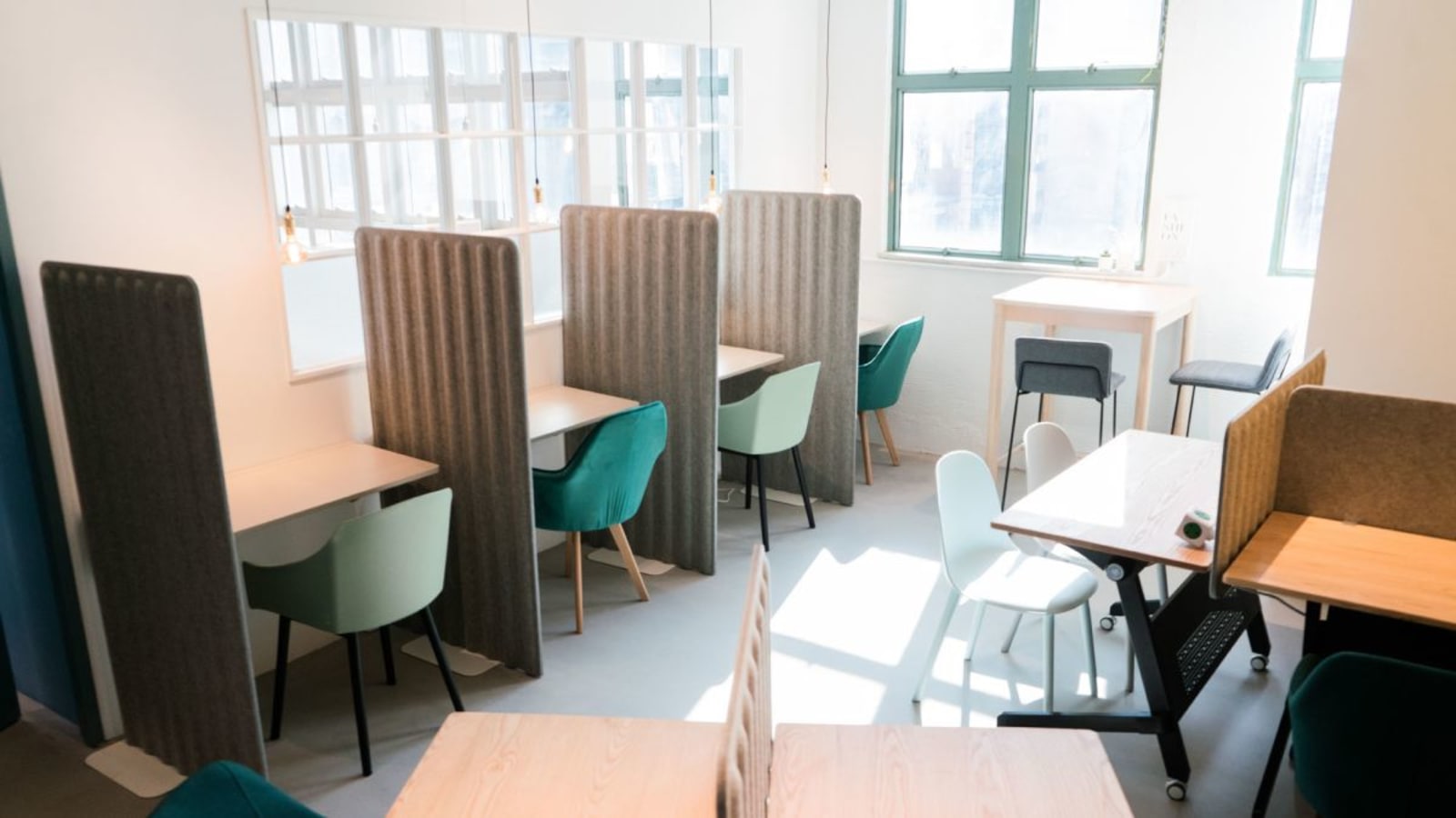 Bright coworking space with privacy dividers and modern seating on How Ming Street, Kowloon.