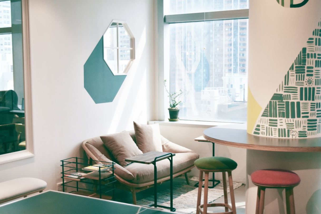 Bright, modern coworking space with cozy seating and vibrant decor. Ideal for collaboration.
