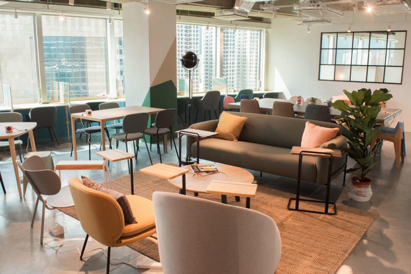 Bright coworking space with modern furniture, ample natural light, and open seating in Sha Tin.