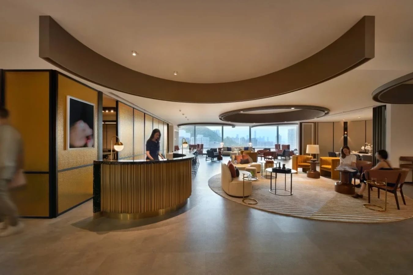 Contemporary coworking space with open layout, modern decor, and cityscape views.