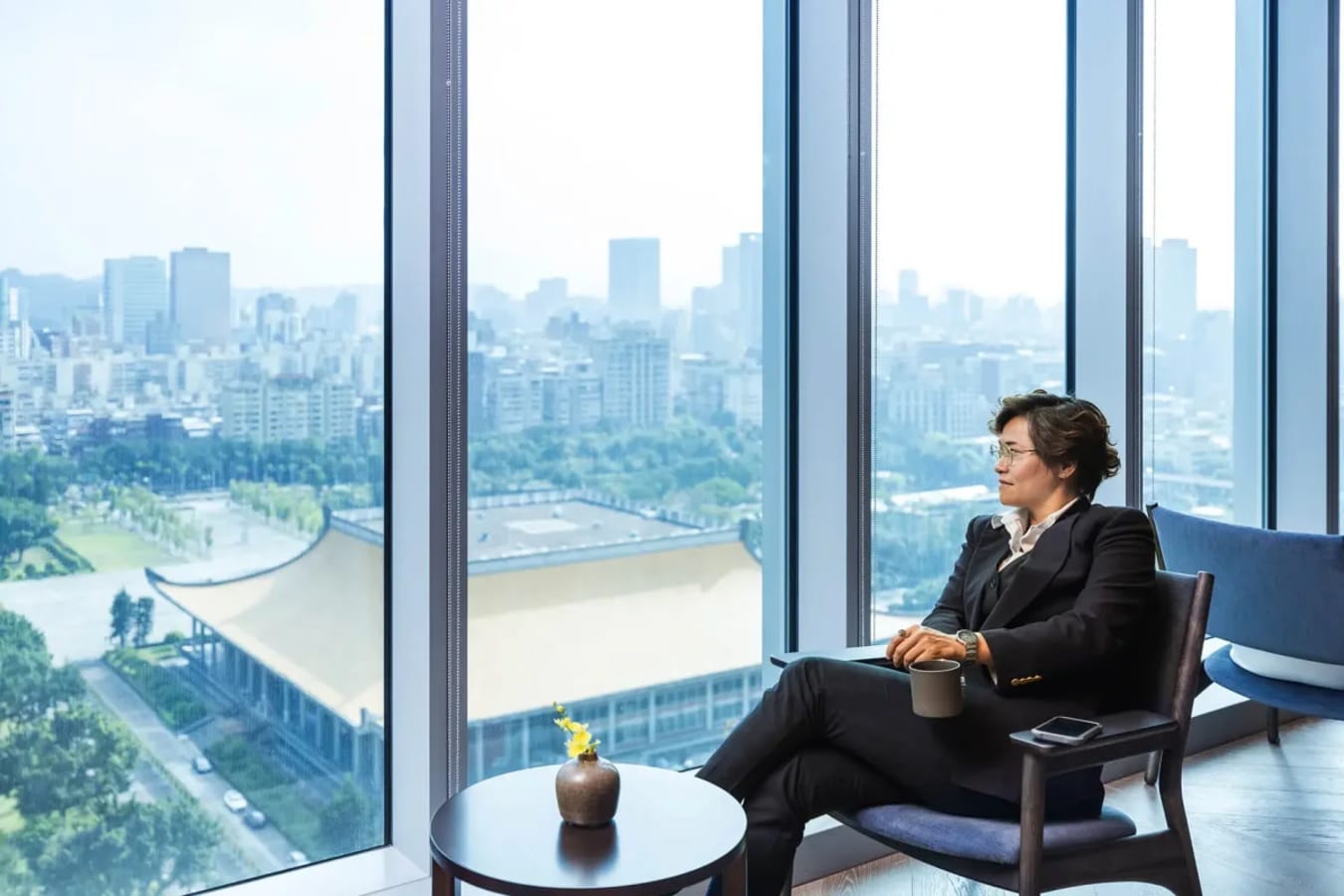 Bright coworking space with stunning city views, modern seating, and natural light.