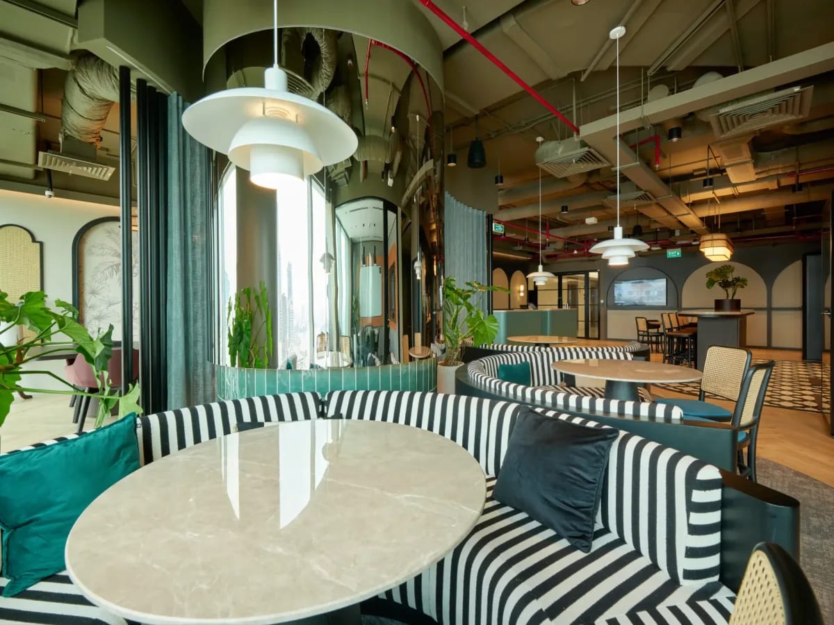 Modern coworking area with chic seating, vibrant greenery, and ample natural light in Saigon Ward.
